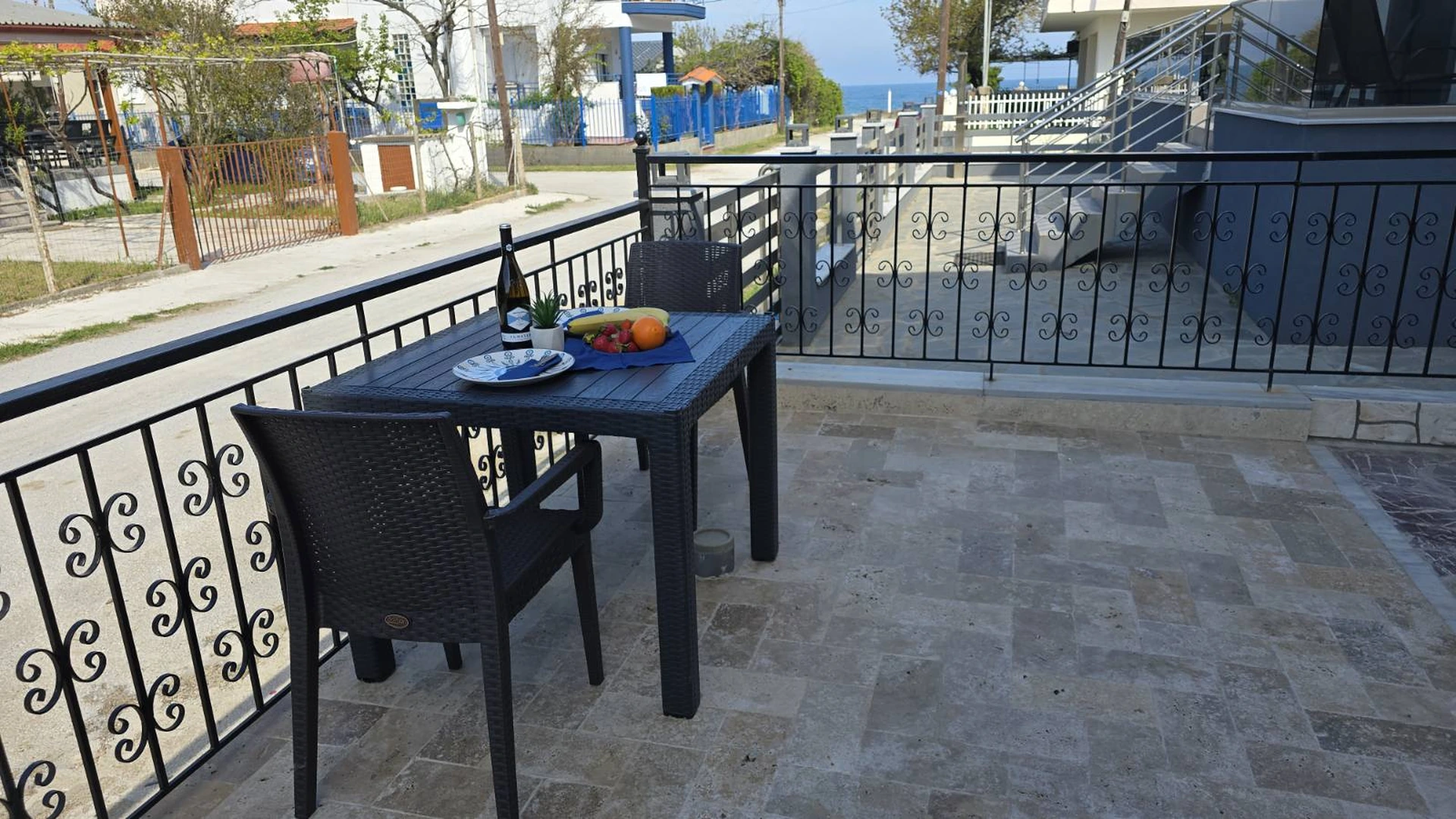Outdoor terrace at Alex Studios with sea visible in the distance